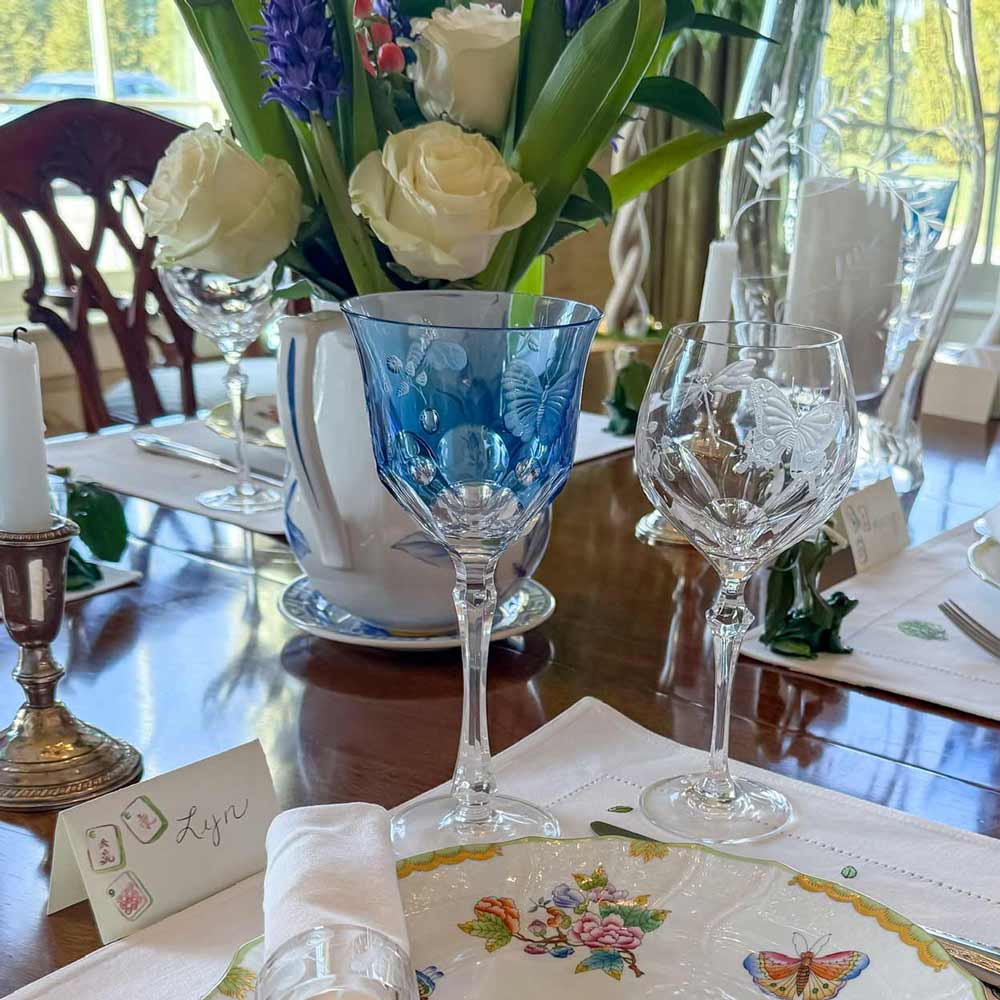 Beautiful tablescape with mahjong themed placecards, fresh flowers and fine china.